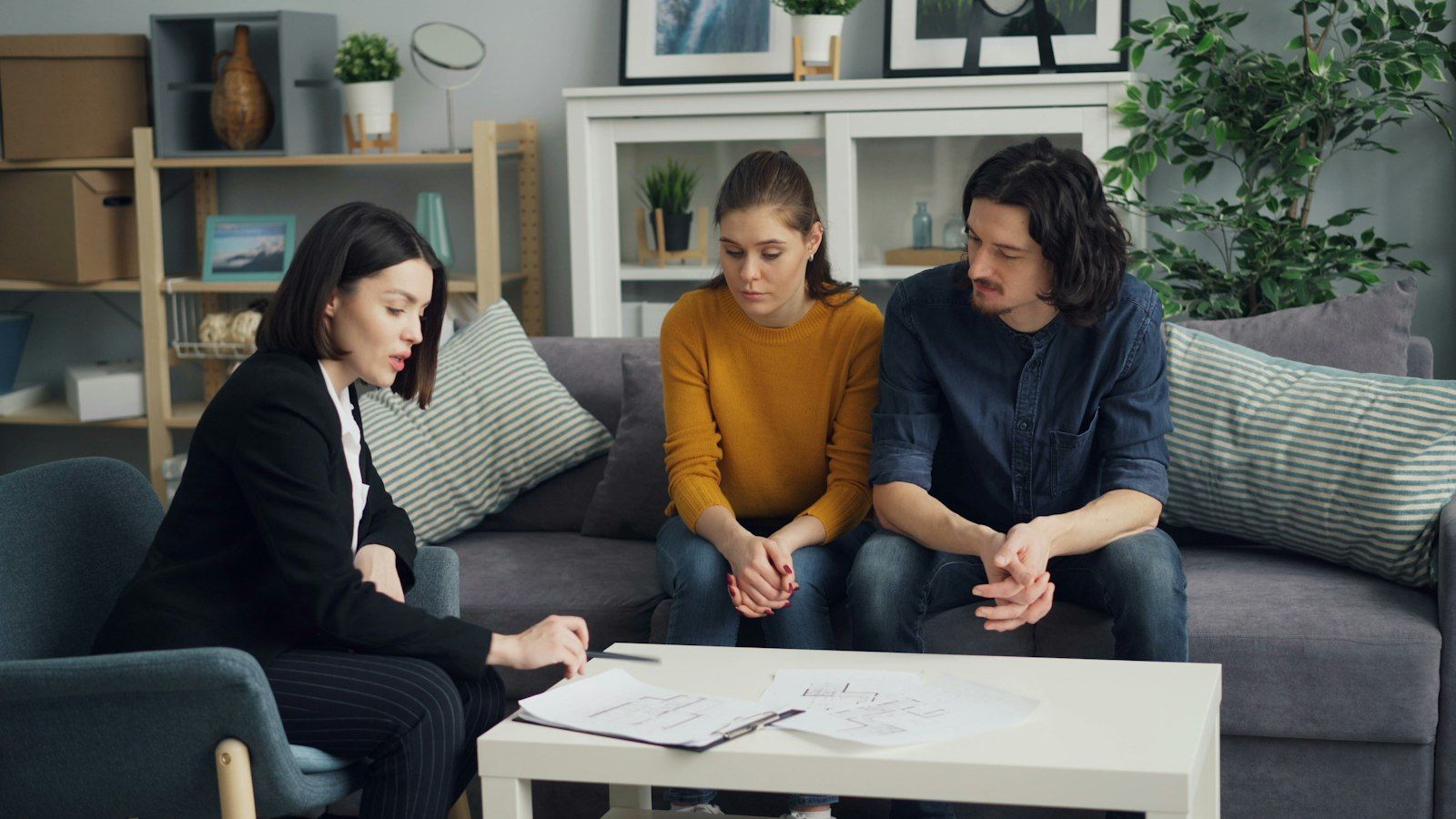 Beratungsgespräch mit einem jungen Paar auf dem Sofa